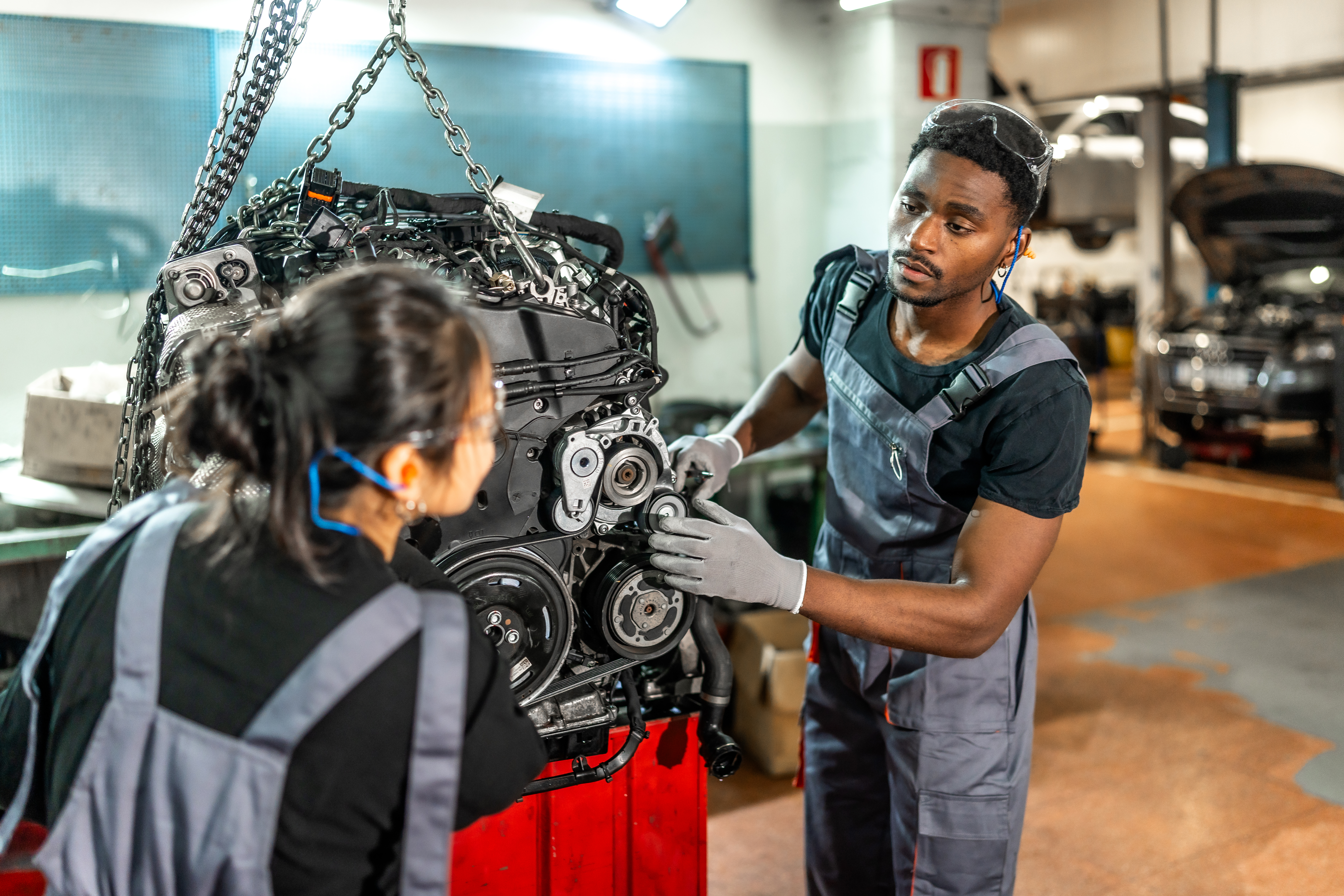 Mechanics working on car engine
